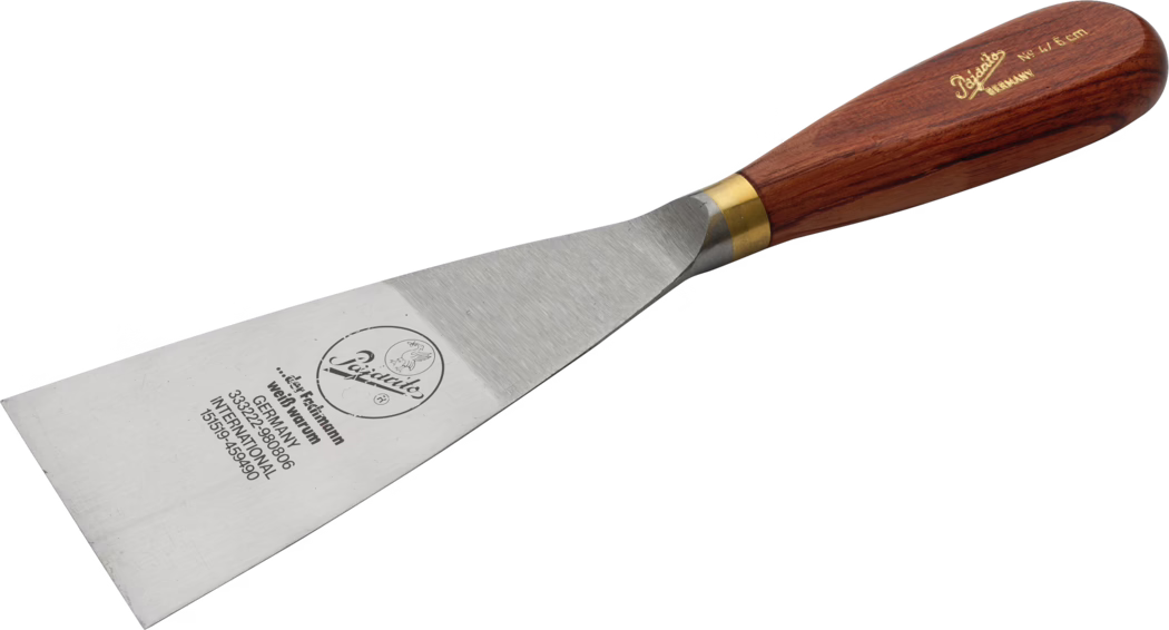 Pajarito_Dummy_Goiter spatula precious wood w brass_034461_034459_060041_060042_060043_034497_2021-02 A high-quality spatula with a stainless steel blade and a wooden handle. The blade is flat and wide, ideal for flipping and serving food. The handle is made of polished wood, providing a comfortable grip, and features a brass band connecting it to the blade, adding both durability and aesthetic appeal.