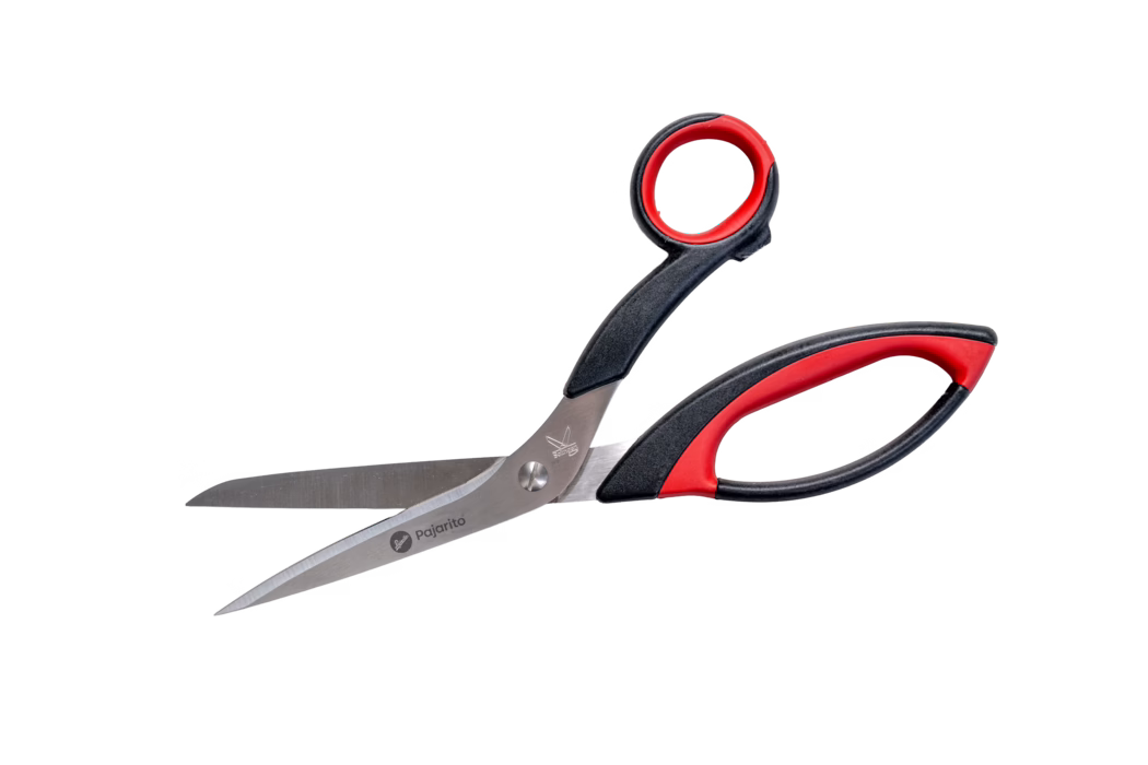 Pajarito_Dummy_Textile scissors_089416_2021-02 A pair of scissors with a metallic blade and black and red plastic handles. The blades are silver with a slight sheen, and the handles are ergonomically designed for a comfortable grip. The scissors are displayed on a plain white background, emphasizing their design and features.