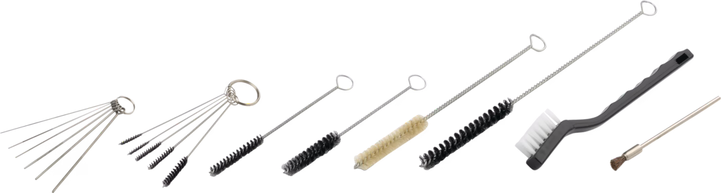 A collection of various cleaning tools, including several wire brushes of different sizes and shapes, a cleaning rod, and a general-purpose cleaning brush. The tools are arranged in a line, showcasing their varying lengths and functions, ideal for detailed cleaning tasks.