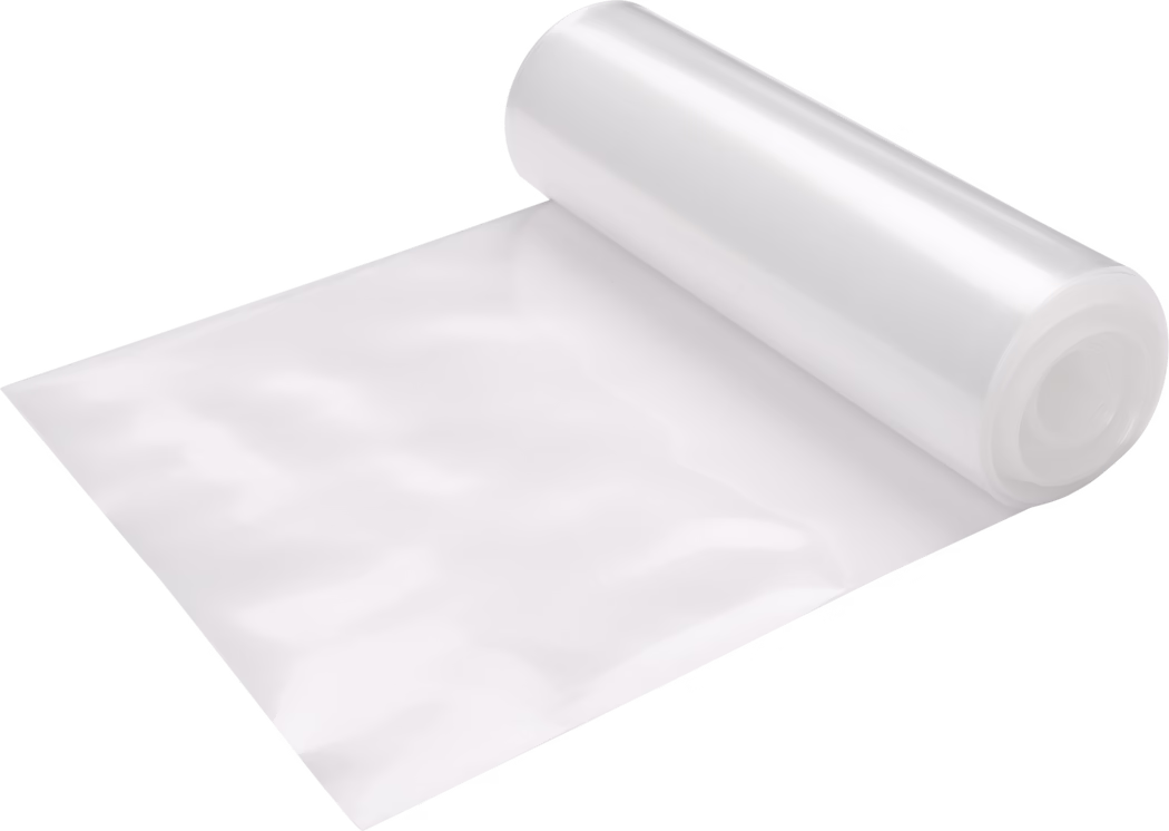 Pajarito_Dummy_Downpipe foil_021517_2021-02 A roll of transparent plastic film partially unrolled, showing a smooth, shiny surface that reflects light. The roll is typically used for wrapping or packaging items to protect them.