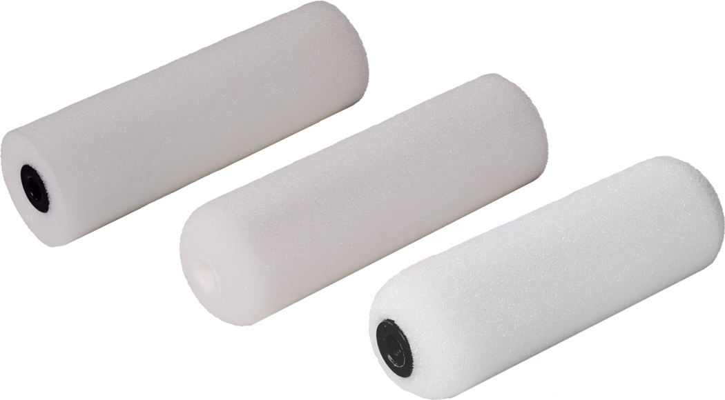 Three white paint rollers with different end caps. The rollers are cylindrical in shape, made of a textured material suitable for painting. They are arranged in a diagonal line, showcasing their various features. The first roller has a black end cap, the second is solid white, and the third also has a black end cap, but slightly different in texture. These paint rollers are typically used for applying paint to surfaces.