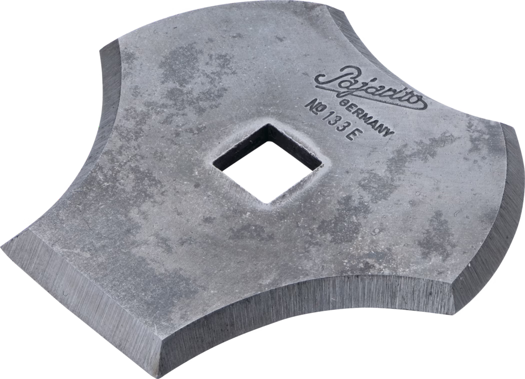 A metallic tool with a unique shape, featuring a square hole in the center and designed with rounded edges. The surface is slightly worn, indicating use. The tool is stamped with 'Pozarito Germany No 133 E'.