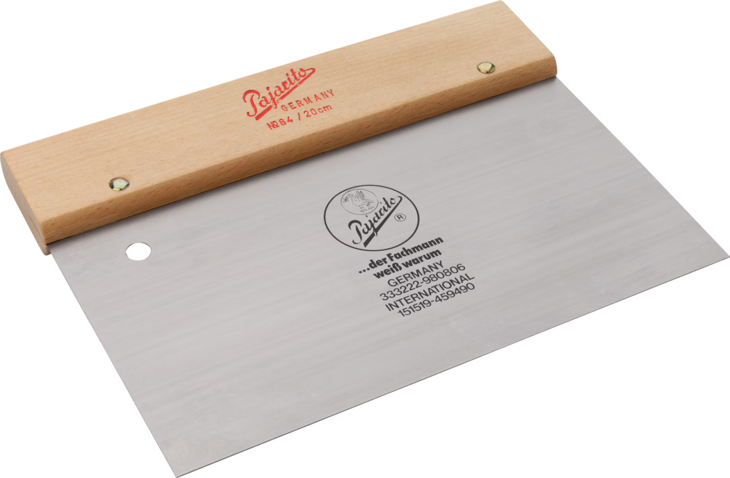 Pajarito_Dummy_Door spatula_034388_034395_2021-02 A high-quality professional scraper with a wooden handle. The blade is made of durable stainless steel, marked with the brand name 'Pajotits' and the country's origin, Germany. The scraper is designed for precision work, featuring a flat edge for smoothing or scraping surfaces. It is an essential tool for craftsmen and artists who require accuracy in their work.