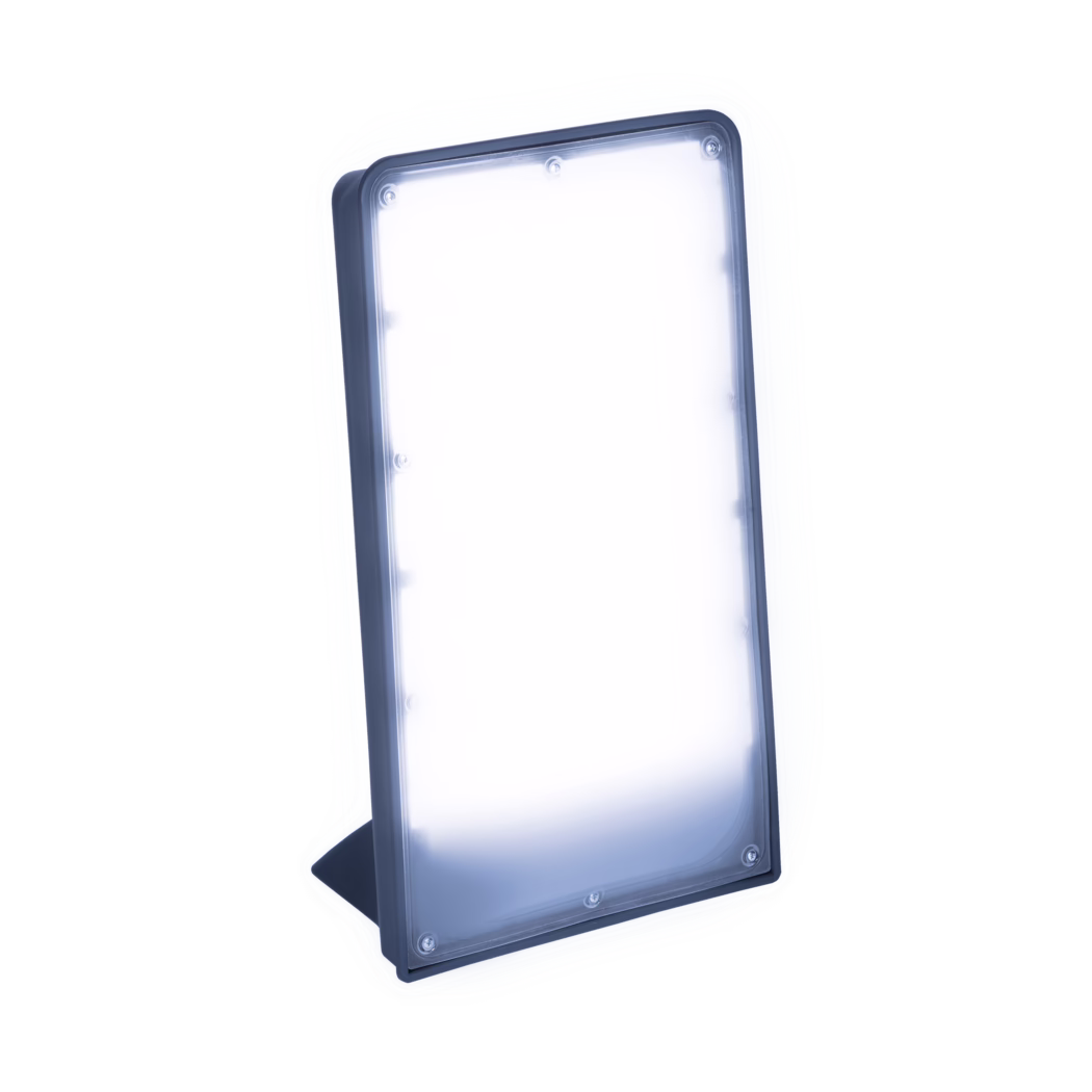 Pajarito_Dummy_Sunrise_177068_2024-07 A rectangular LED light therapy panel mounted on a small angled stand, showing bright cool-white diffused light inside a dark blue plastic frame, photographed against a white background.