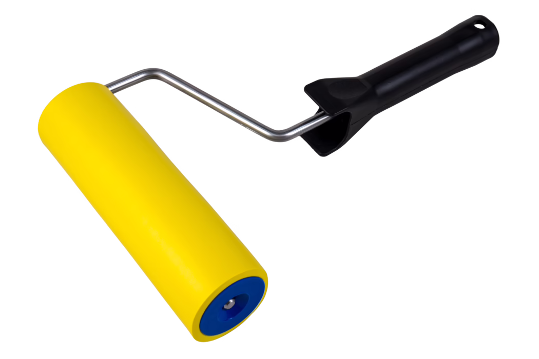 Close-up of a yellow foam paint roller with blue end caps, a shiny metal frame and an ergonomic black plastic handle photographed on a white background; suitable for applying paint to smooth surfaces.